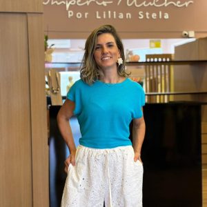 Modelo vestindo blusa azul, com manga curta ampla, gola arredondada e caimento soltinho.